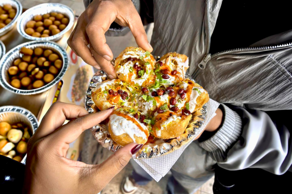A serving of Indian chaat topped with chutneys and crunchy sev.