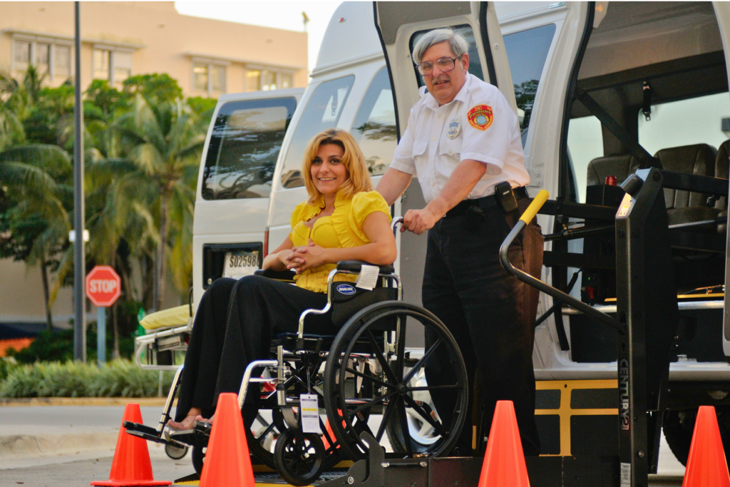 A passenger using a wheelchair receiving assistance with accessible transport.